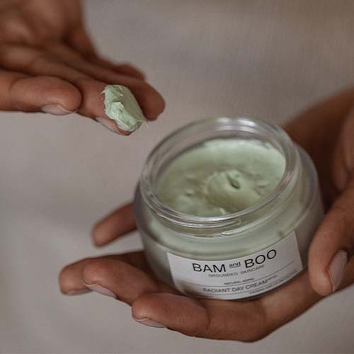 Women Holding Open Jar - Cream Texture - Radiant Day Cream - Best Sellers Collection - BAMandBOO Grounded Skincare Azores
